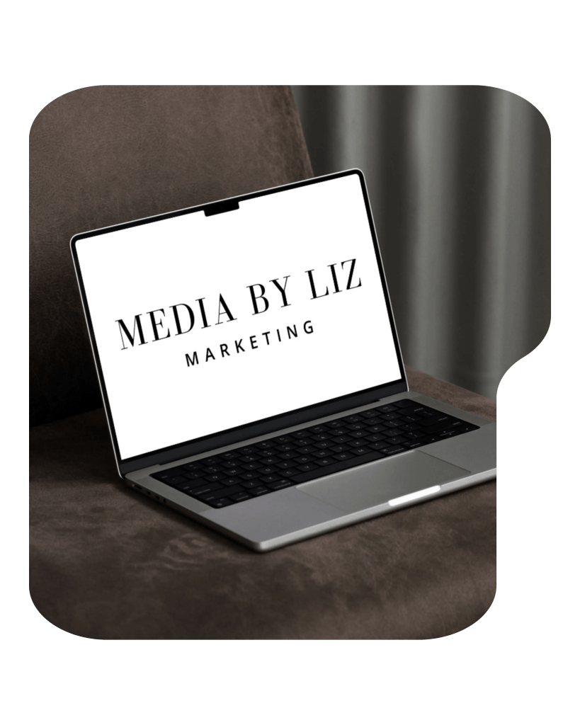 Creative workspace with laptop, brand boards, and coffee cup representing Media By Liz website and branding design work.