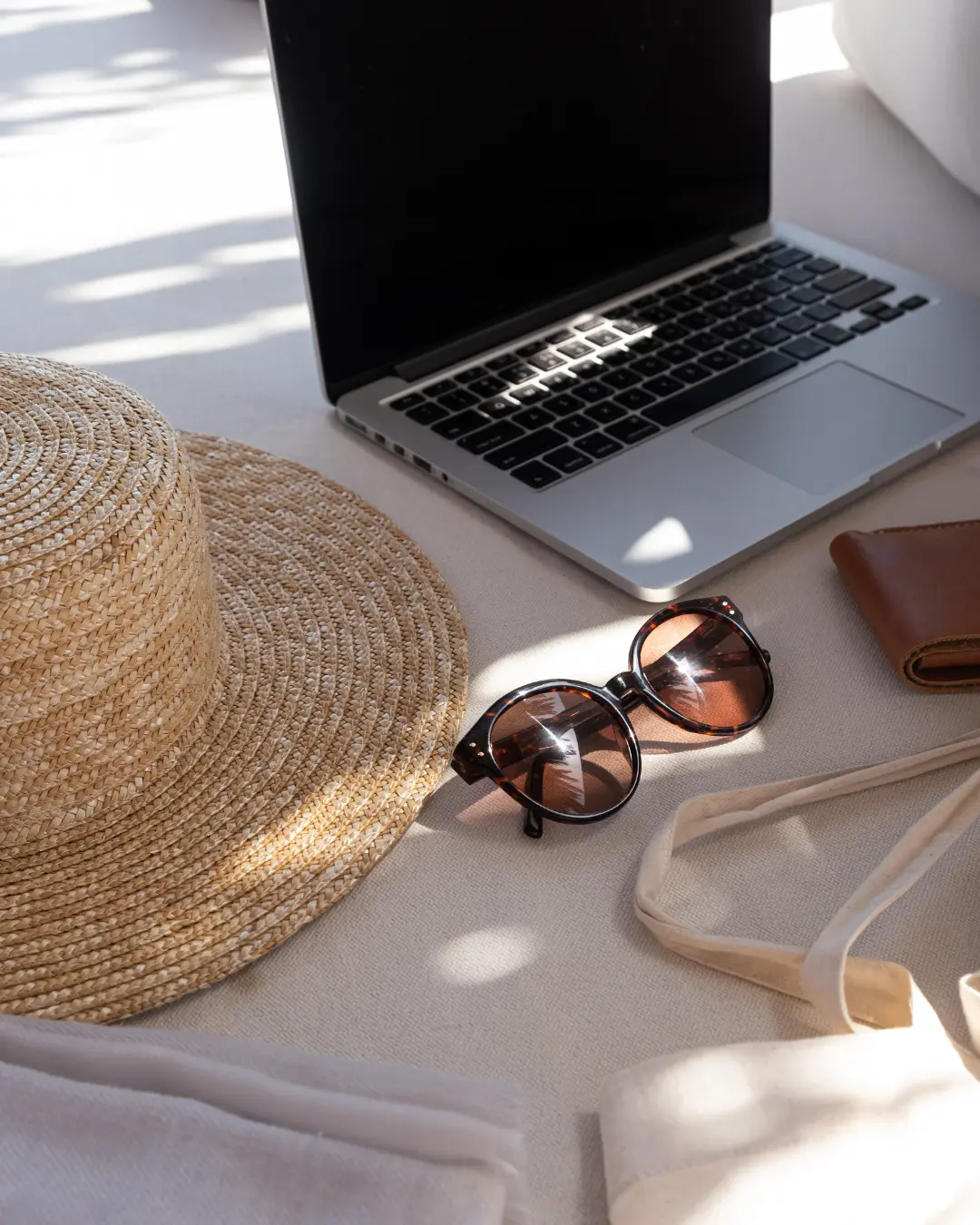 Creative lifestyle workspace with laptop, sunglasses, and accessories representing content creation and digital marketing for MBL Marketing.